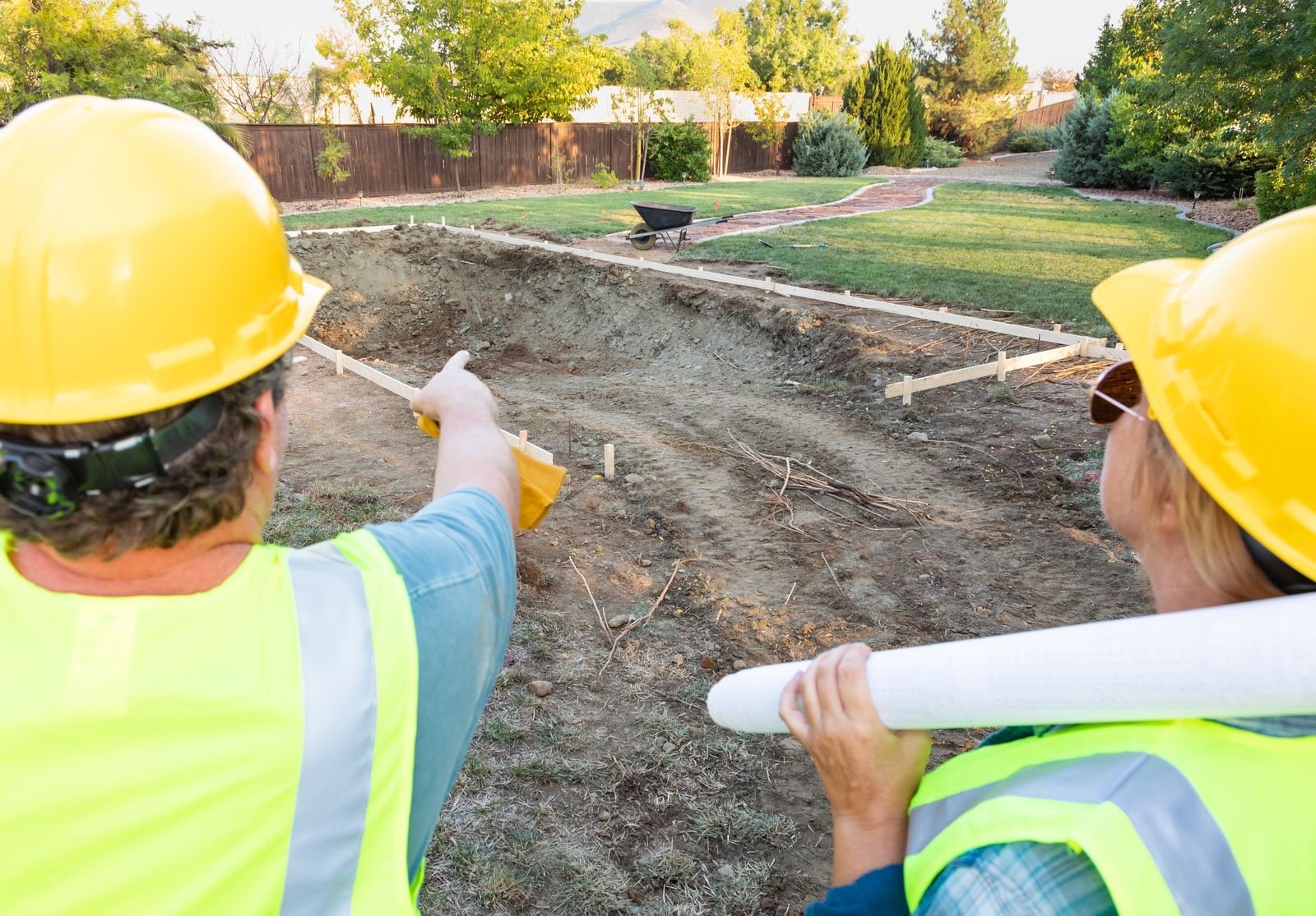 Workers planning a backyard project